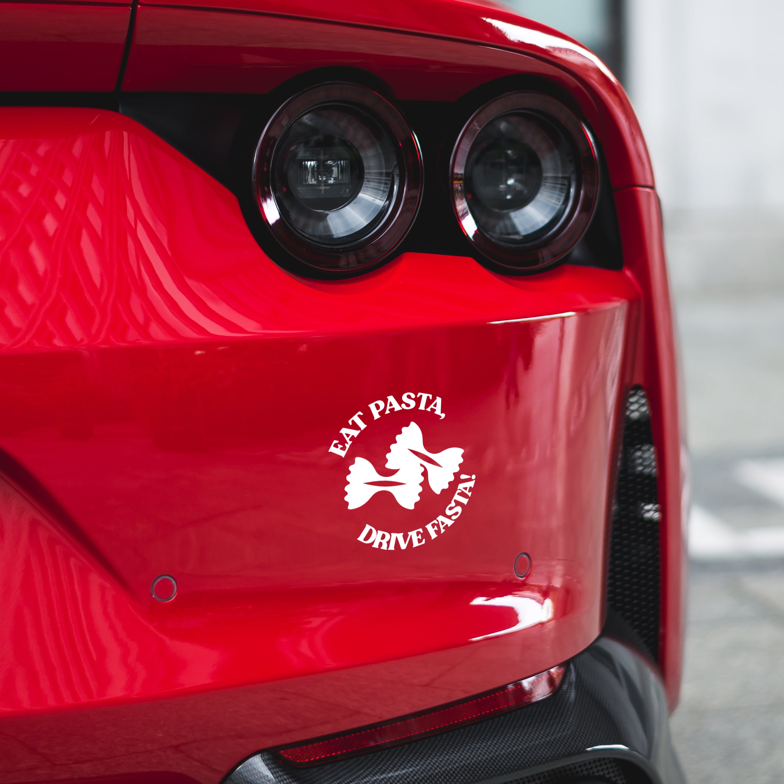eat pasta drive fasta sticker on red ferrari