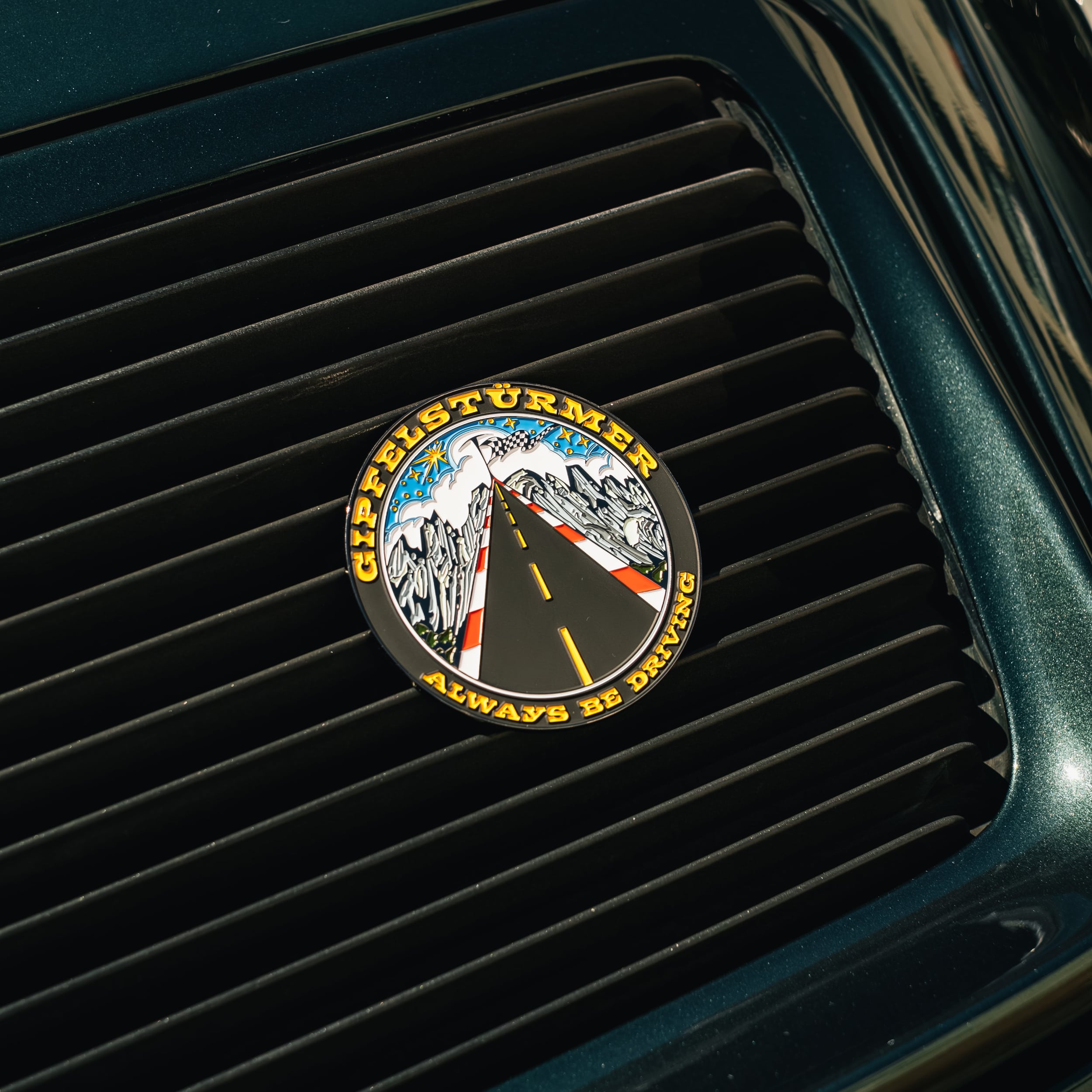 enamel car grill badge gipfelstuermer on green porsche