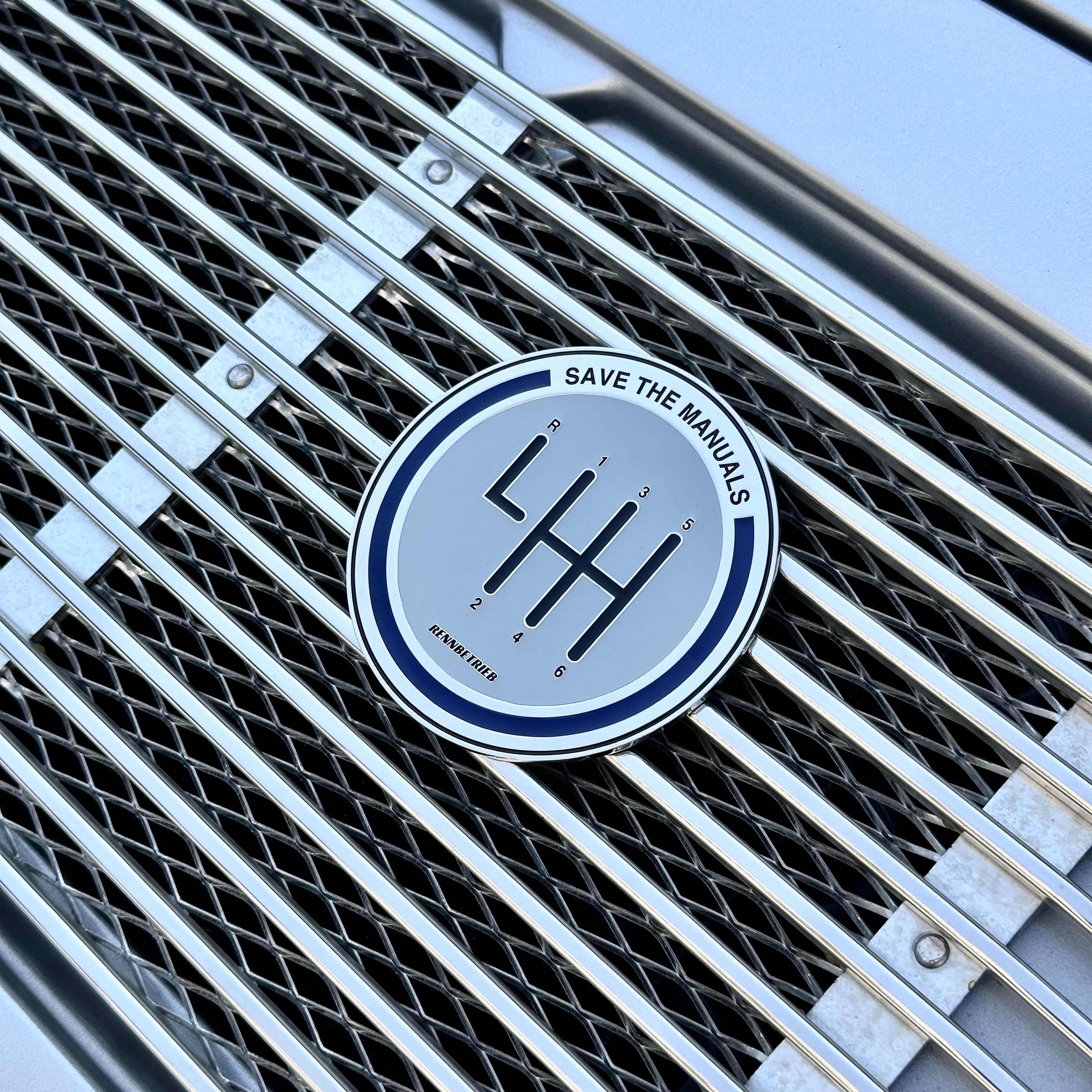 rennbetrieb save the manuals enamel grill badge on silver porsche