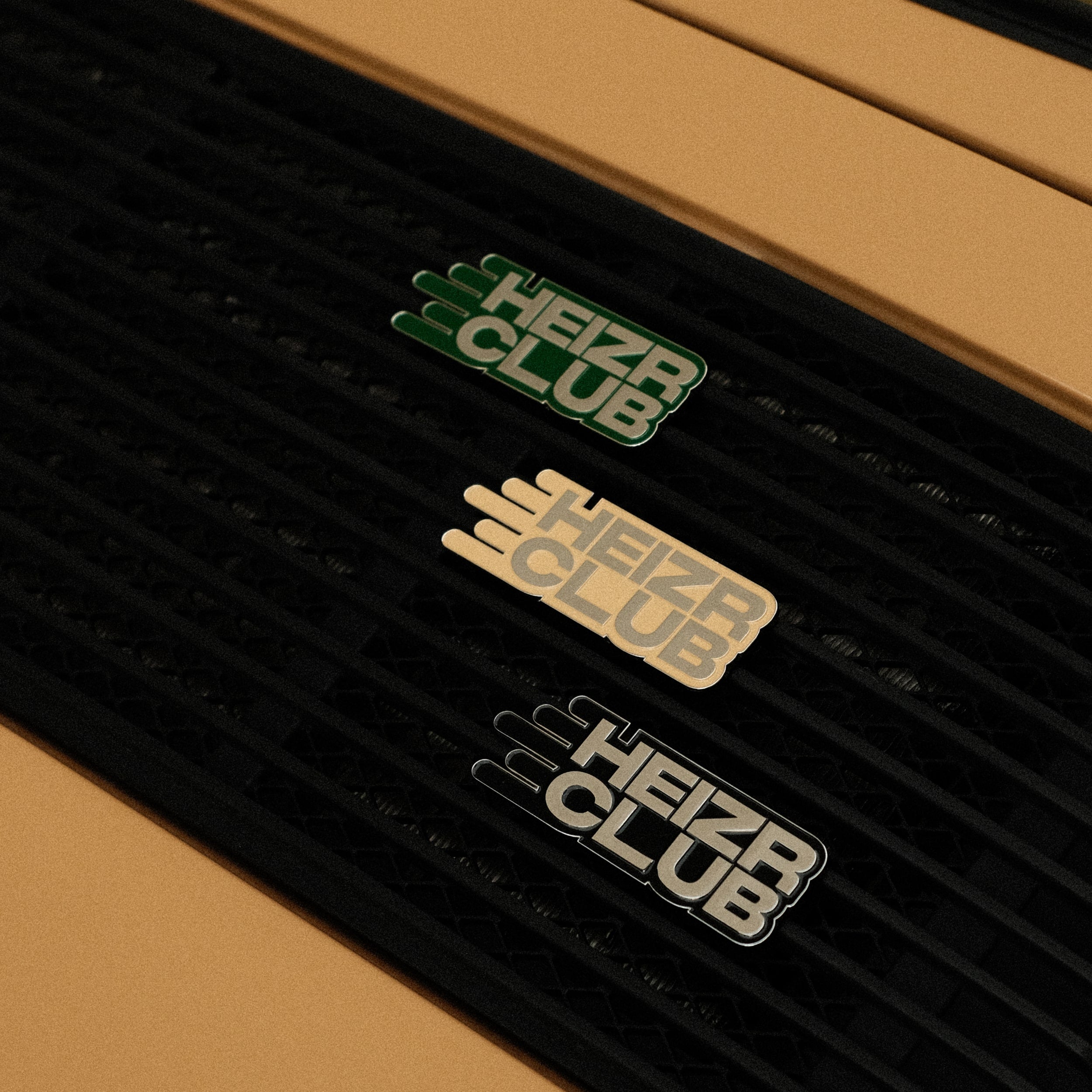 RENNBETRIEB x HEIZR Club Enamel car grill badge on beige car