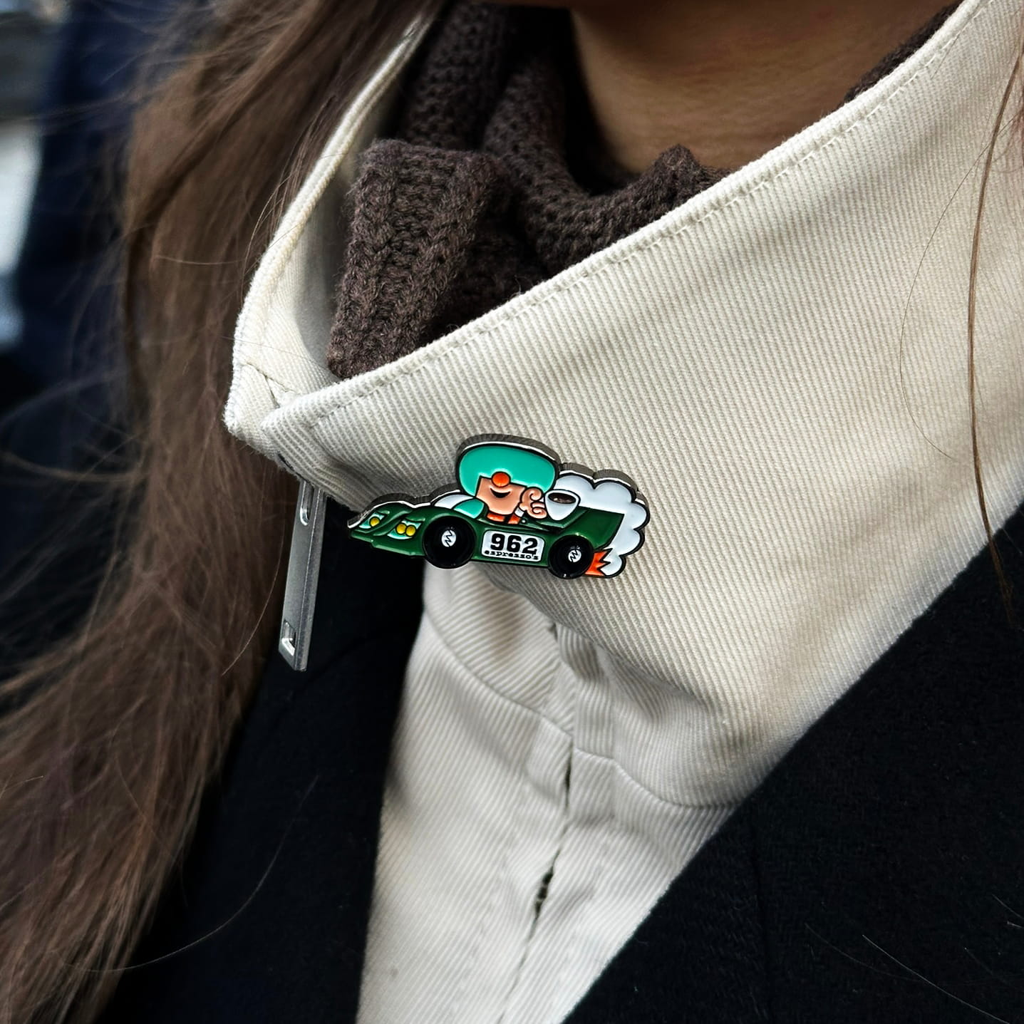 group c Pin on a lapel of a person wearing a coat