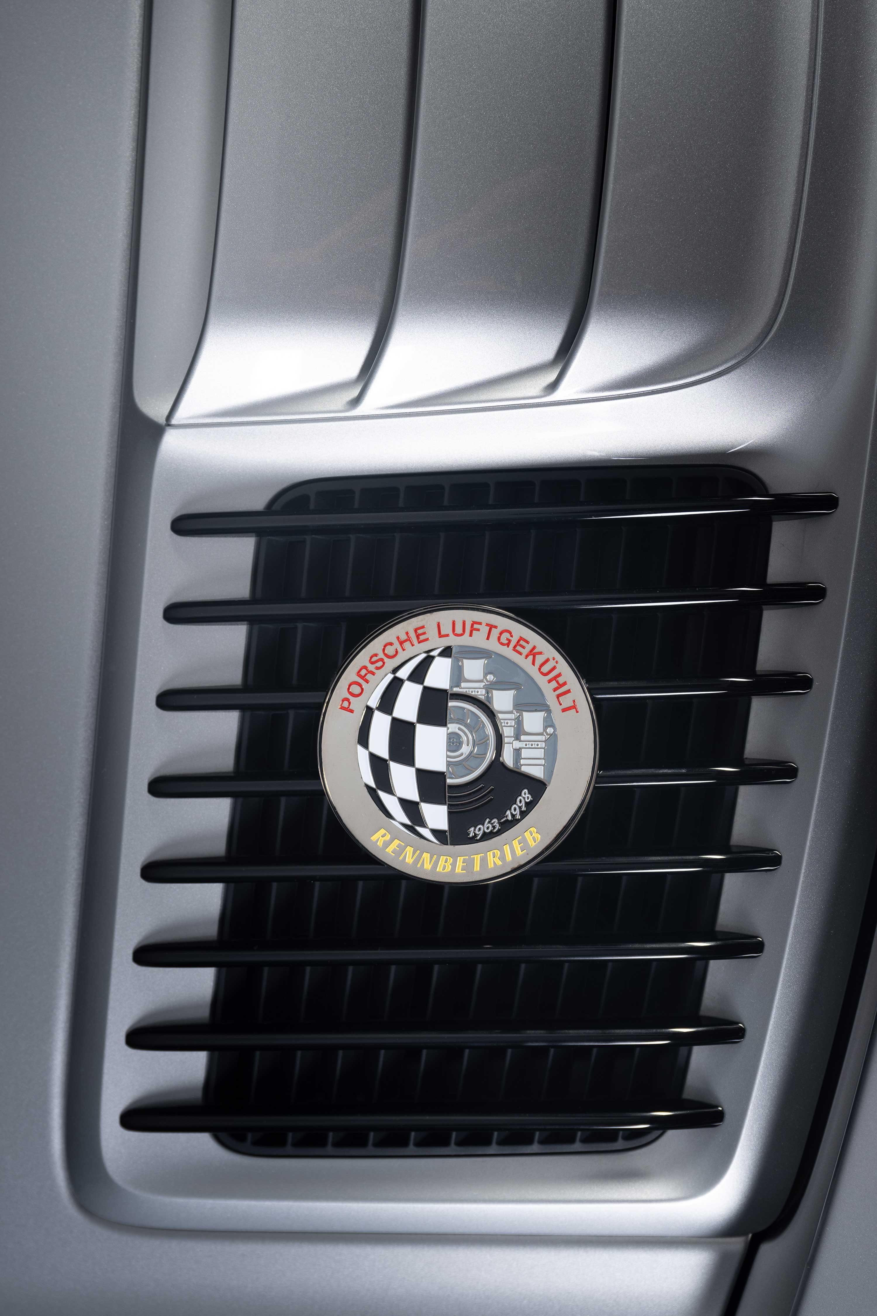 porsche in silver with luftgekühlt enamel badge on car grill