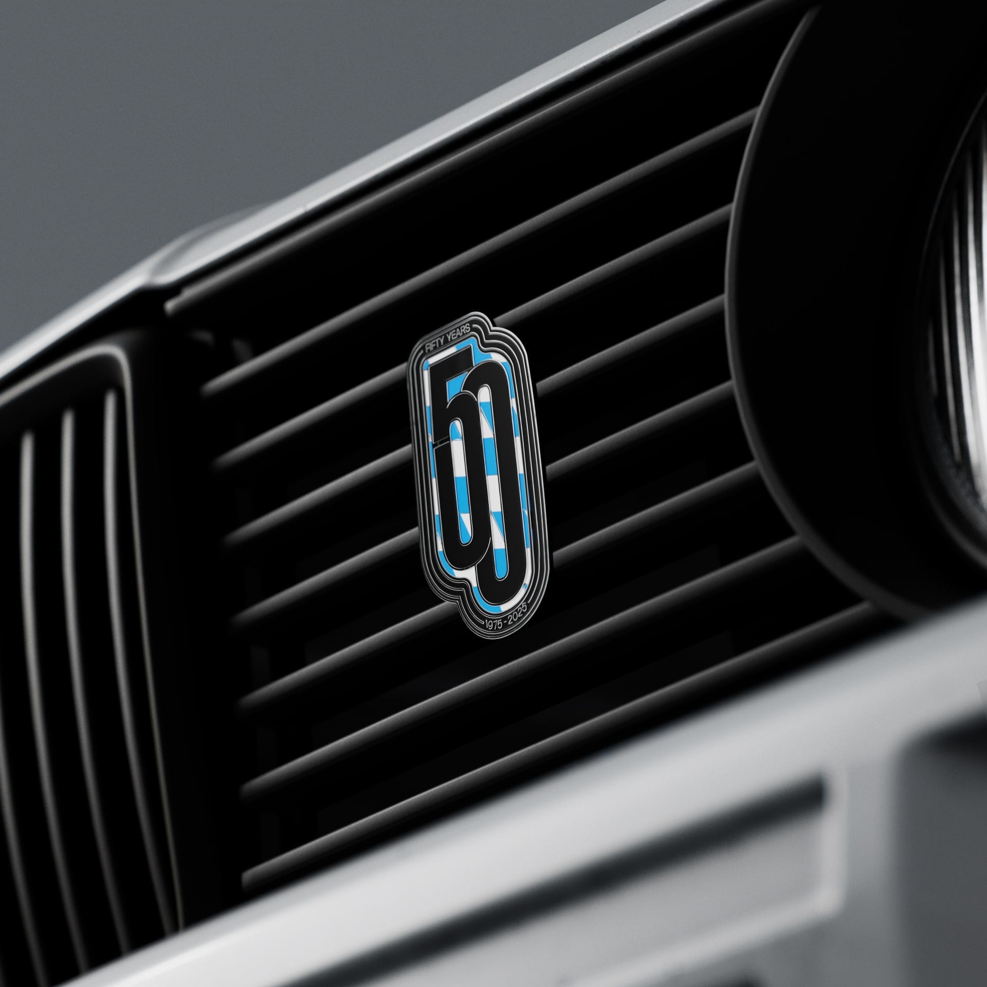 Car air vent with a logo on a dark background