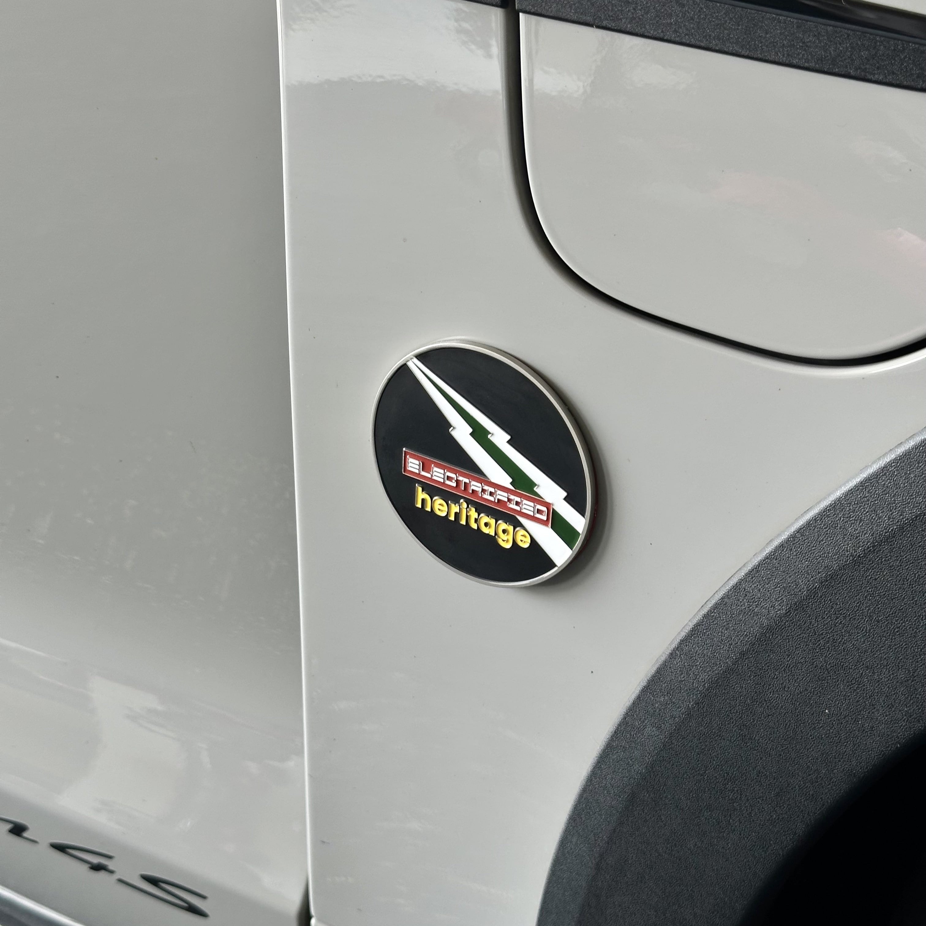 electrified heritage enamel grill badge on porsche taycan