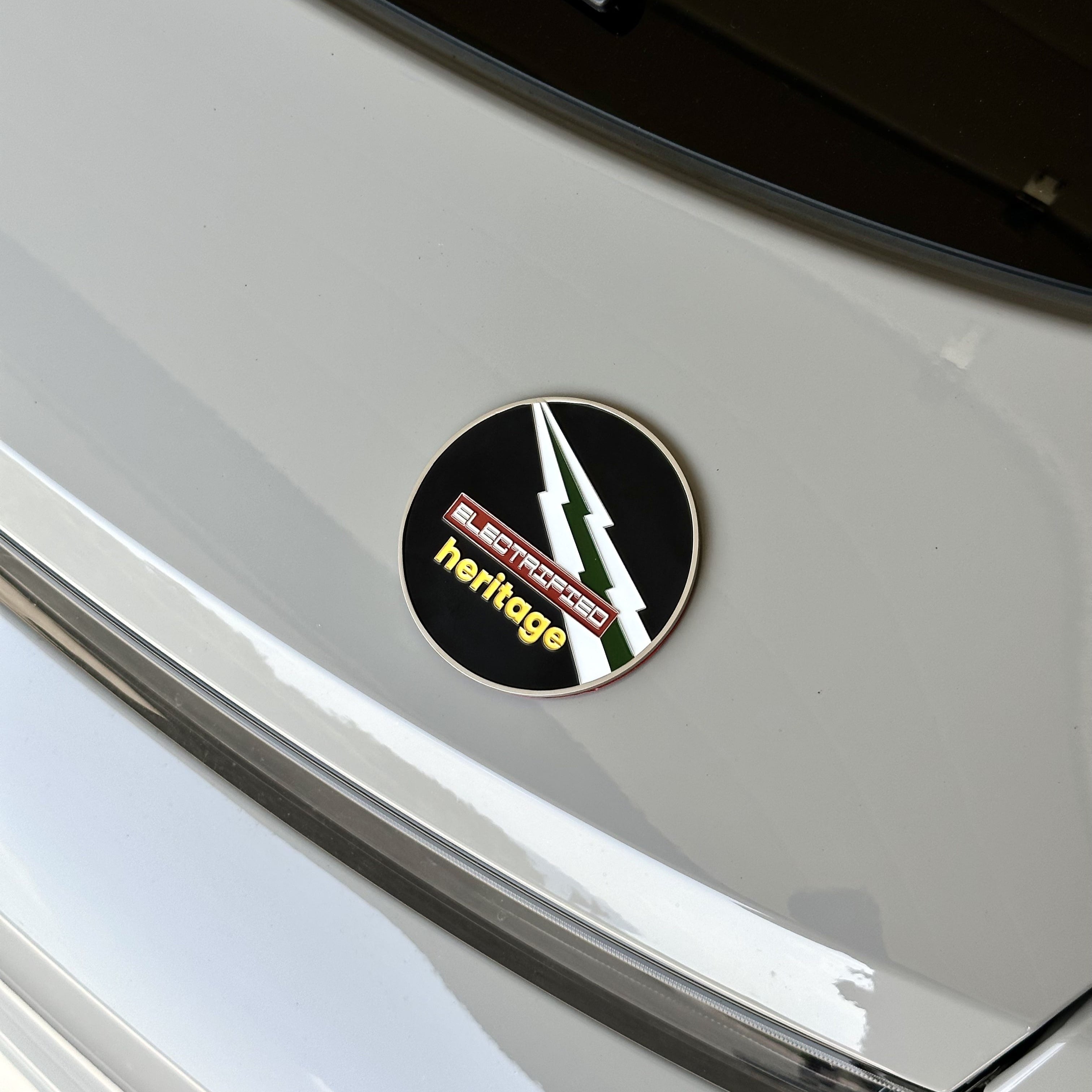 electrified heritage enamel grill badge on porsche taycan