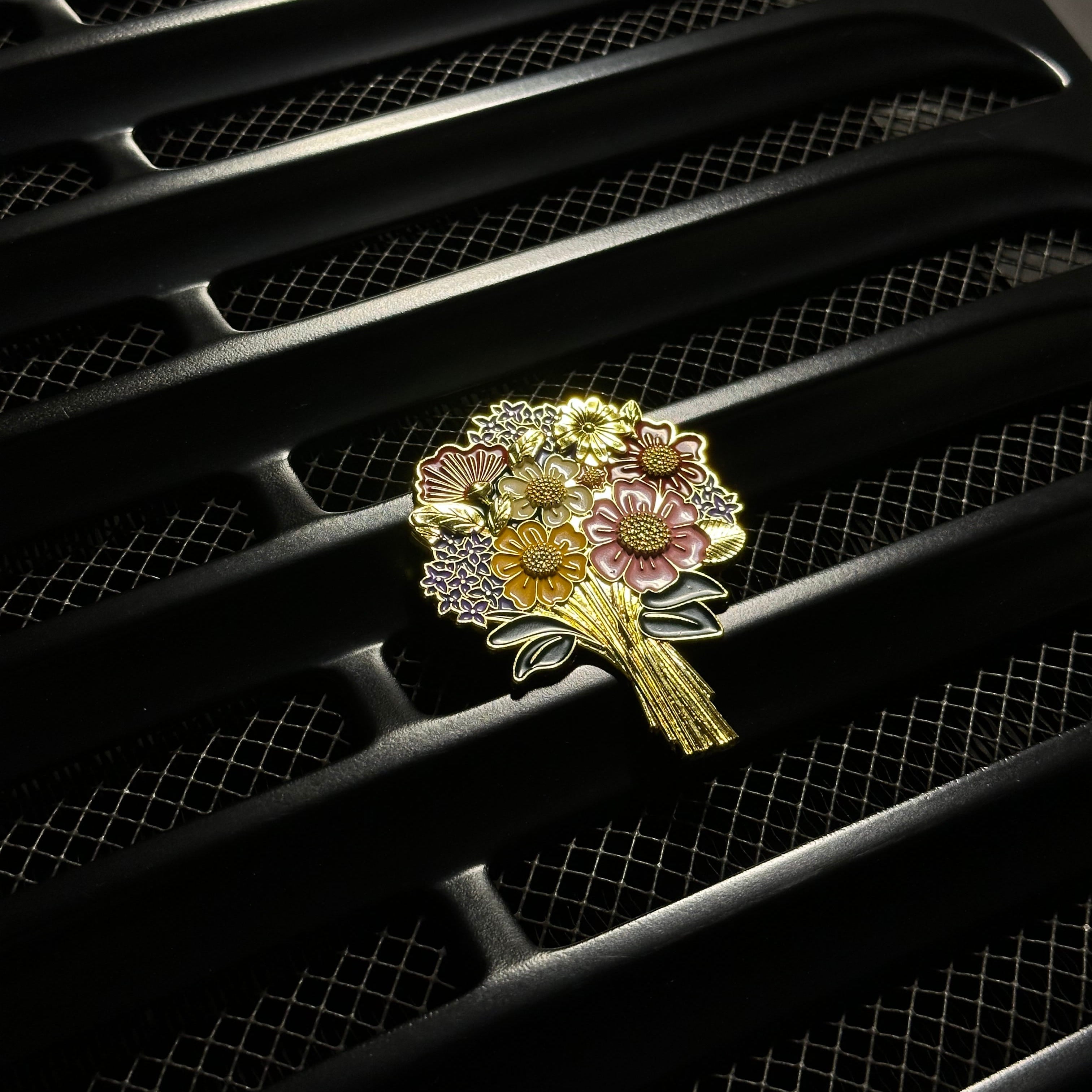 Decorative brooch with floral design on a car grille
