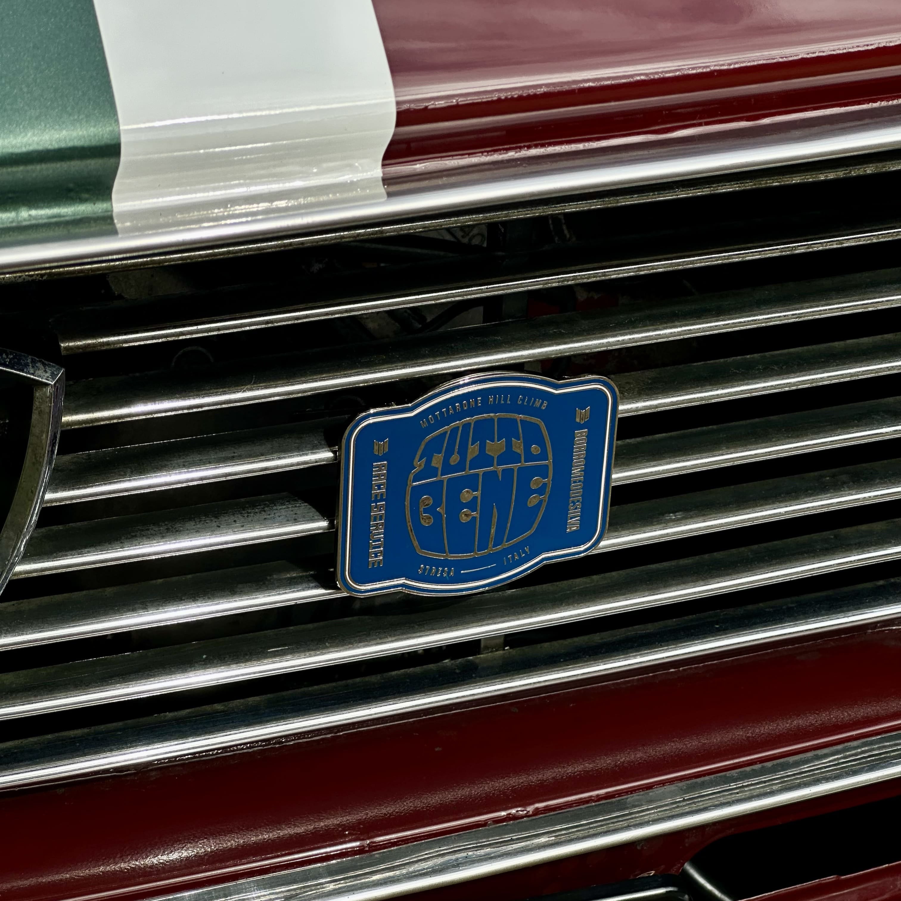 rennbetrieb x tutto bene hill climb enamel badge on red lancia fulvia