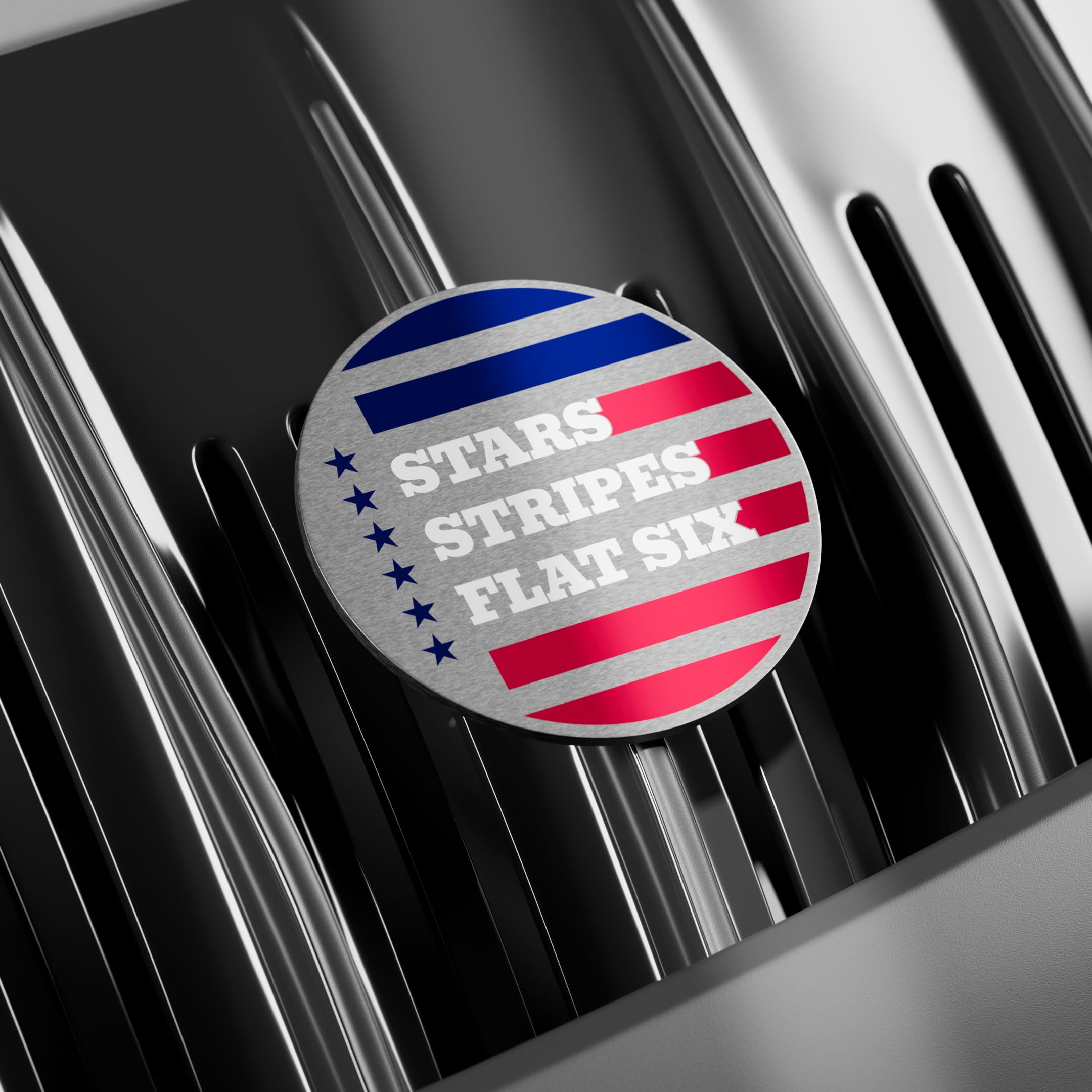 Round badge with 'Stars Stripes Flat Six' text on a porsche grille